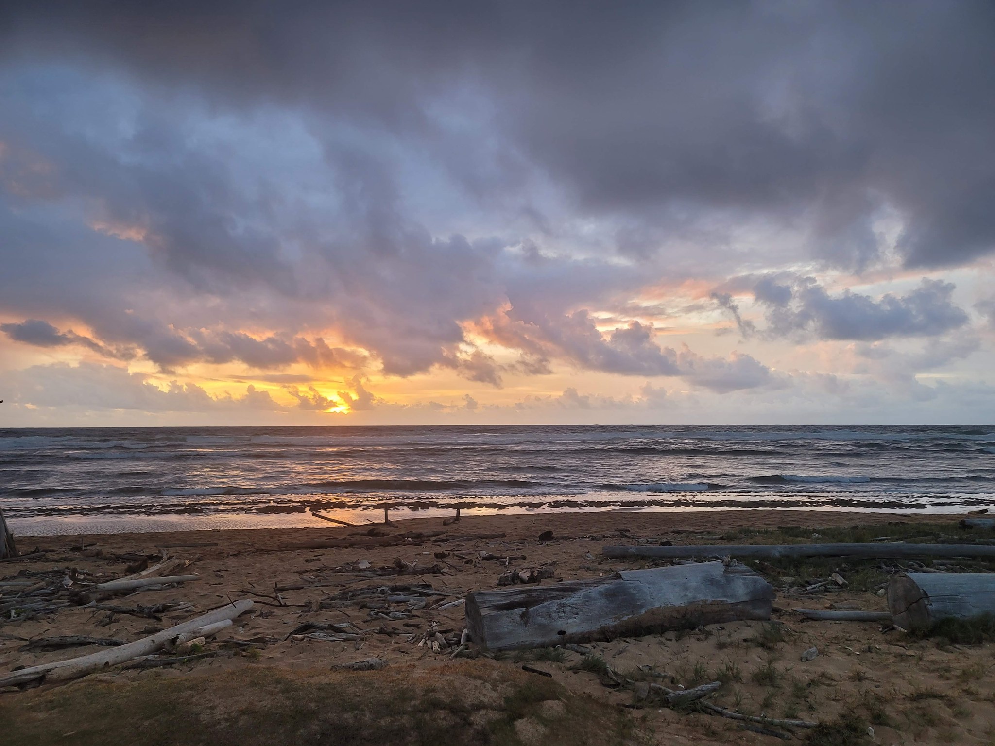 Sunrise over the ocean from a driftwood beach on the east coast of Kauai